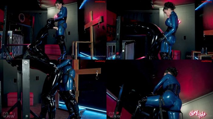 Evil Woman – Rubber gimp destroyed in the stocks